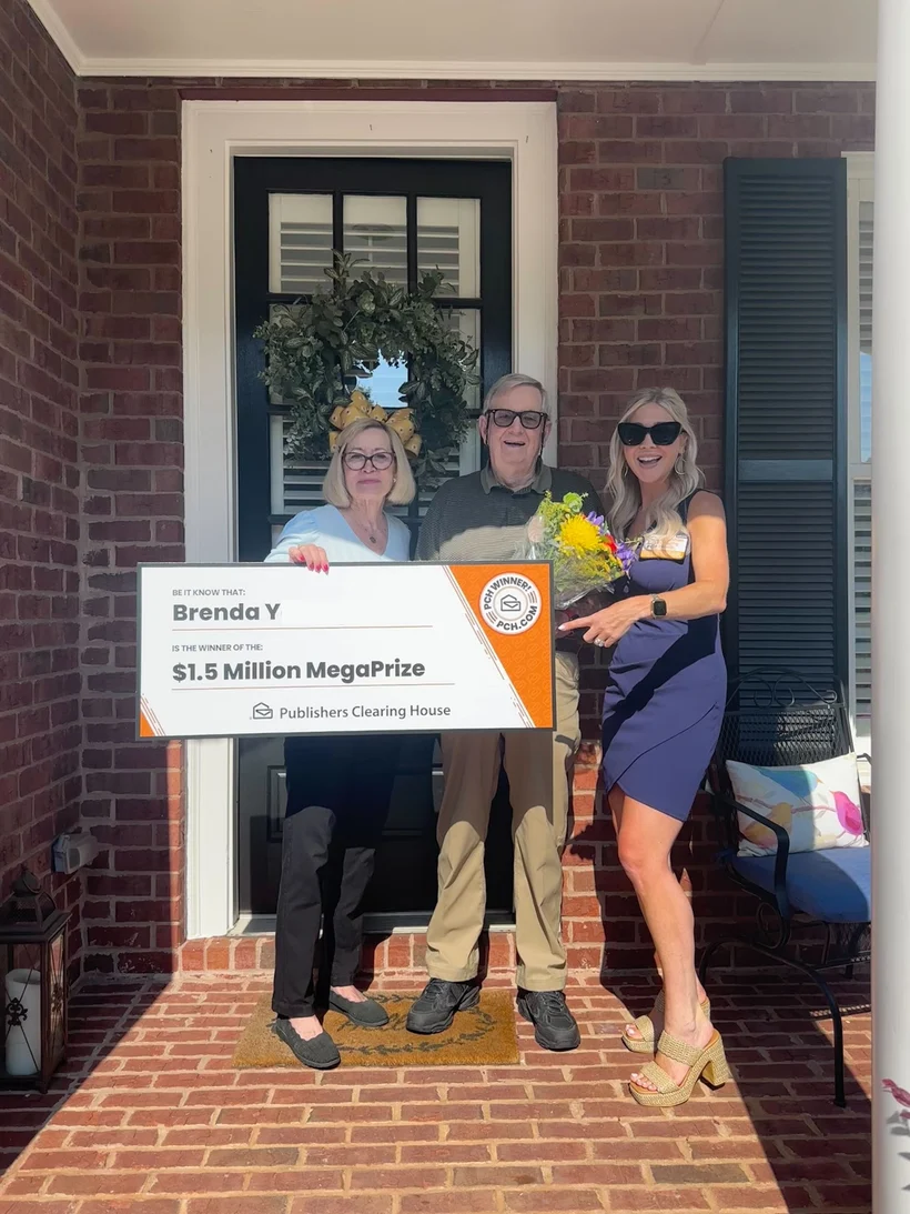 Brenda Y holding her big check